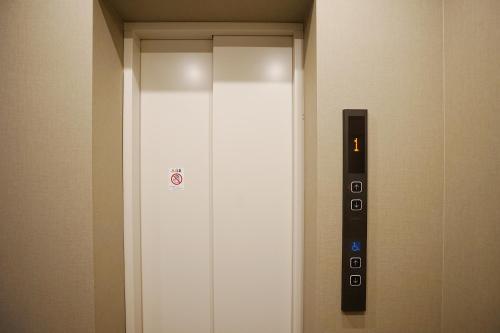 a elevator in a building with a sign on it at 川HOUSE黒門 in Osaka