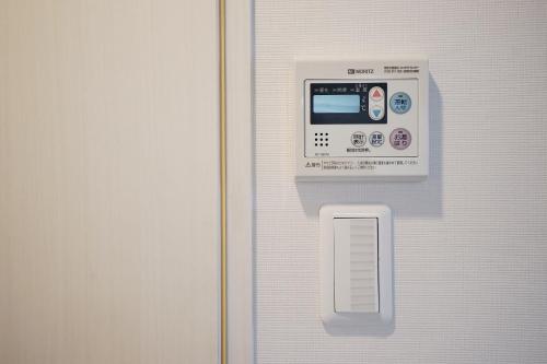 a door with an electronic device on it at 川HOUSE黒門 in Osaka
