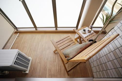 a balcony with a bench and a table with a fan at 川HOUSE黒門 in Osaka