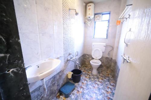 a bathroom with a sink and a toilet at THE CROFT HOUSE MAHABALESHWAR in Mahabaleshwar