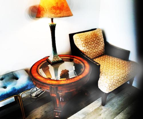 a room with a table and a chair and a lamp at Aeolian Ranch Guest house in Kailua-Kona