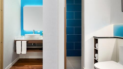 a bathroom with a sink and a mirror at Holiday Inn Express Xining Railway Station, an IHG Hotel in Xining