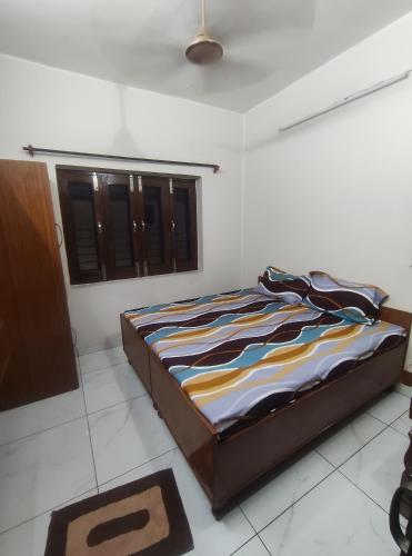 a bedroom with a bed in a room at Himalaya Inn Guest House in Jalandhar
