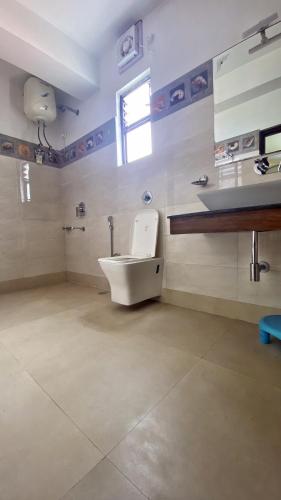 a bathroom with a toilet and a sink at Lingmoo Residency in Ravangla