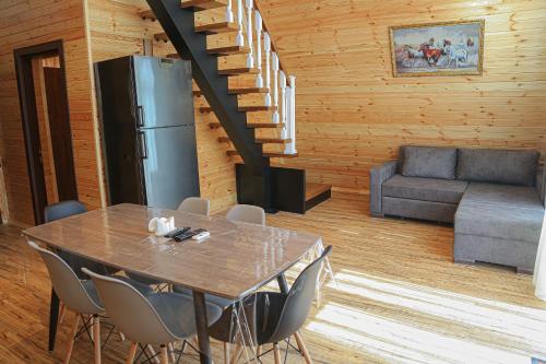 a dining room with a table and a refrigerator at Triangle Villa Gabala. in Gabala