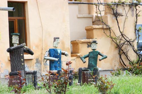 three statues of men standing in front of a building at Guest house 17/7 in Gyumri