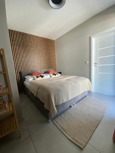 a bedroom with a bed with a rug next to it at HELove Apartamenty in Hel