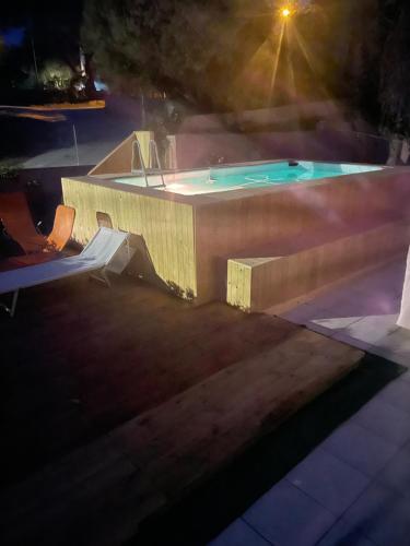 a swimming pool at night with the lights on at Villa Diana affitta camere in Stintino
