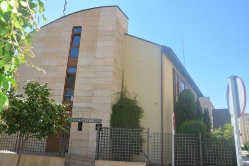 a building with a fence in front of it at PR Rosa Rosae in Santiago de Compostela