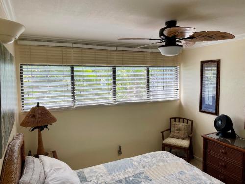 a bedroom with a bed and a ceiling fan at Ka Hale Kealoha in Kaunakakai