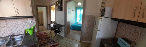 a kitchen with a sink and a counter top at Elektra's apartment central with parking in Argostoli