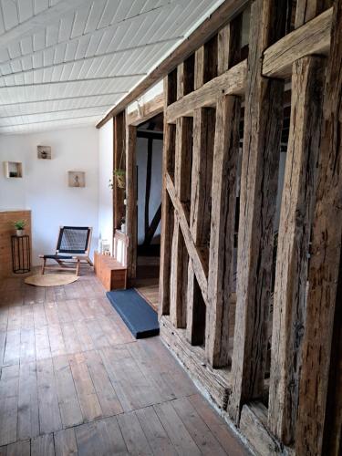 a room with a wooden wall with a sliding barn door at Bienvenue chez vous 