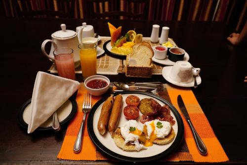 a table with a plate of breakfast food on it at Mandira Strathdon by HPL in Watawala