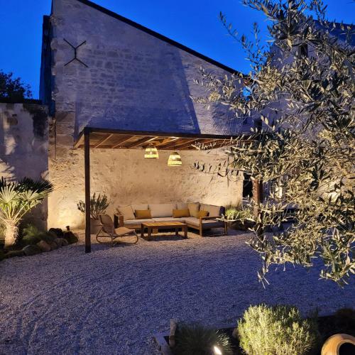 an outdoor patio with a couch and a table at Hôtel Rive Sud in Chinon