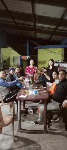 a group of people sitting around a table at ANURAG HOMESTAY in Kurseong