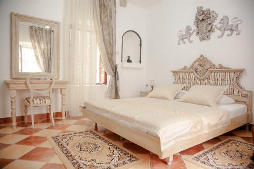 a bedroom with a large bed and a chair at Casa Antica Druško in Kotor