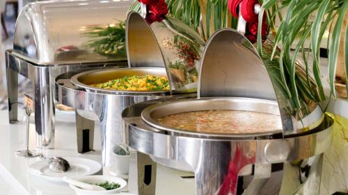 two food trays with food in them on a counter at Seaside Boutique Resort Quy Nhon in Quy Nhon