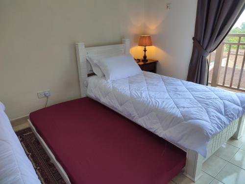 a bedroom with a large bed with a window at Sofea Inn Bukit Merah - Suria A7733 in Kampong Selemat