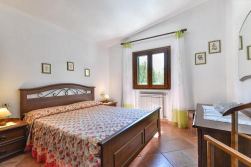 a bedroom with a large bed and a window at Casa Neda in Procchio