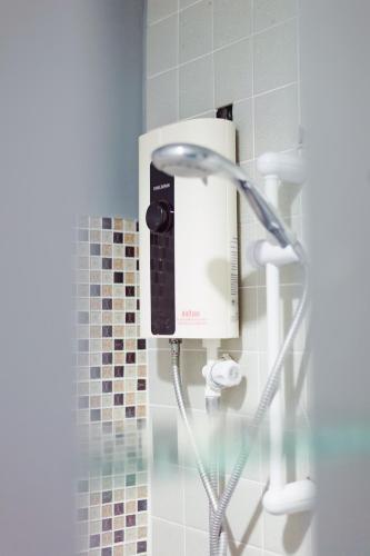 a shower in a bathroom with a shower head at Siray Green Resort in Phuket