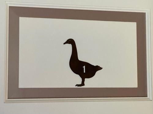 a picture of a duck silhouette on a wall at L'ocanda Rancioli in San Casciano dei Bagni
