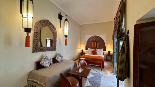 a hotel room with a bed and a mirror at Riad Jardin Des Rêves in Marrakech