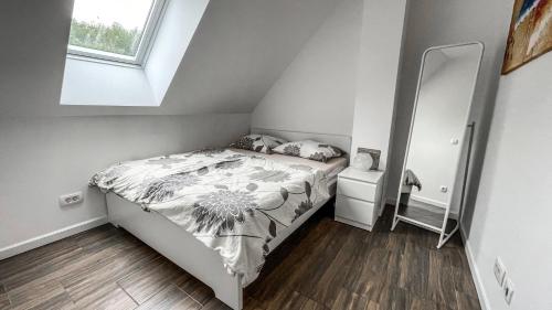 a small bedroom with a bed in a attic at Apartment Jezero Lake Bohinj in Bohinj