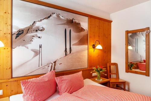 a bedroom with a bed with red and white pillows at Alpenflora 2 in Ischgl