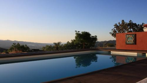 een zwembad met uitzicht op de bergen bij Casa Maliyaa in Almáchar