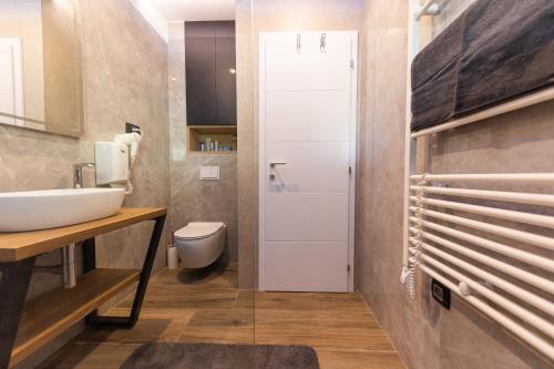 a bathroom with a sink and a toilet at Orange Apartment&Spa Okrug Gornji in Trogir