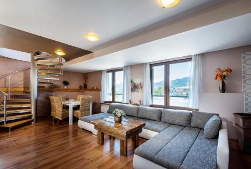 a living room with a couch and a table at Apartments Sofia plus in Liptovský Mikuláš