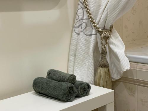 a pile of towels sitting on a shelf in a bathroom at SAULETEKIO APARTMENT in Vilnius