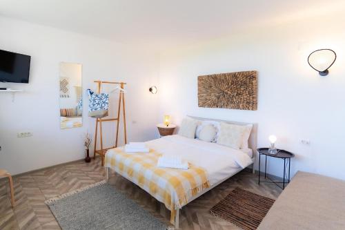 1 dormitorio con 1 cama grande y TV en Rezident Corbu, en Corbu
