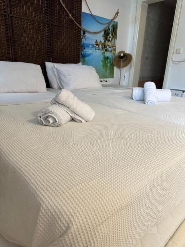 two white towels are sitting on a bed at Galini Relax Suite in Rafina
