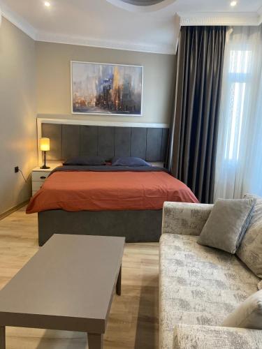 a bedroom with a red bed and a couch at The House Company in Istanbul