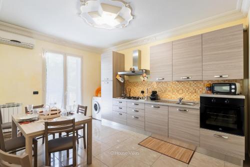 a kitchen with a table and a dining room at House&Villas - Casa Amica in Avola