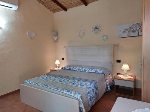 1 dormitorio con 1 cama y 2 lámparas en las mesas en Agriturismo Agrisole, en Olbia