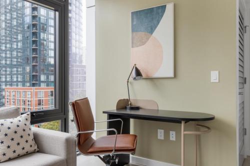 a living room with a desk and a chair and a window at First Hill 1BR w Gym Patio Coworking SEA-435 in Seattle