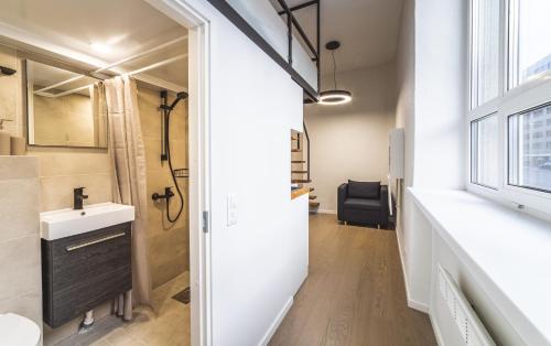 a bathroom with a sink and a toilet and a window at City Apartments in Tallinn