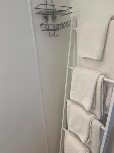 a towel rack with white towels in a bathroom at The Laurels Hotel in Skegness