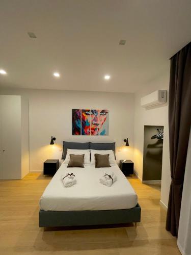 a bedroom with a large bed with two pillows on it at Summertime in Bisceglie