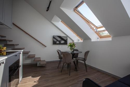 une cuisine et une salle à manger avec une table et une lucarne dans l'établissement M8 Modern Two-Floor Apartment, à Kaunas