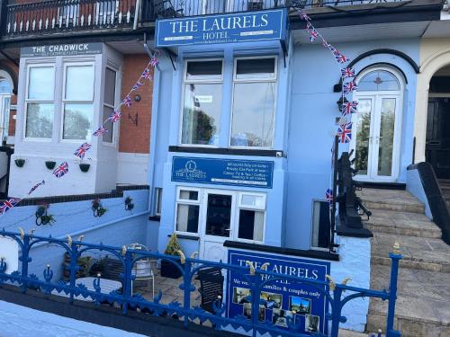 a blue building with a sign for the lancers hotel at The Laurels Hotel in Skegness