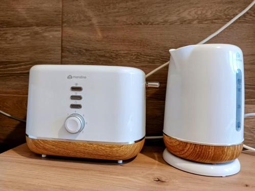 two toasters sitting next to each other on a table at Lend City Apartment in Miercurea-Ciuc