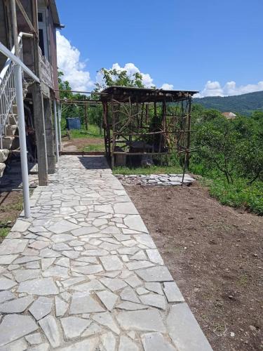 a stone walkway next to a building at Чкалов гостевой дом in Chʼkalov
