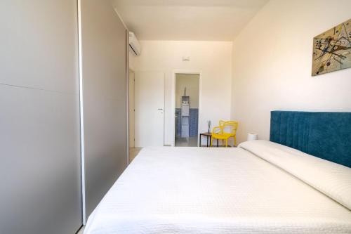 a bedroom with a bed and a chair at Villa Katia - Ostuni in Villanova di Ostuni