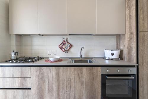 a kitchen with a sink and a stove at Villa Katia - Ostuni in Villanova di Ostuni