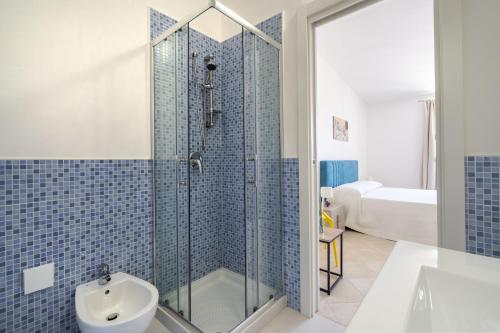 a bathroom with a shower and a toilet and a sink at Villa Katia - Ostuni in Villanova di Ostuni