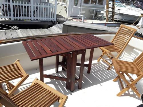 a wooden table and two chairs on a deck at Waterfront 32' Bayliner Yacht in Providence