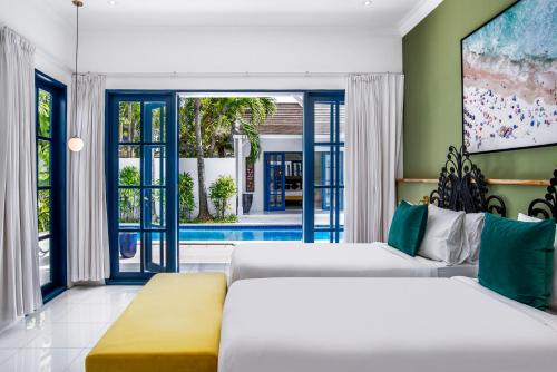 a bedroom with two beds and a pool at The Beach House in Canggu